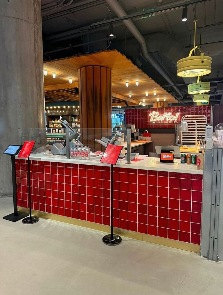 Modern restaurant counter with red tile facade, white countertop, and wooden architectural elements under warm lighting